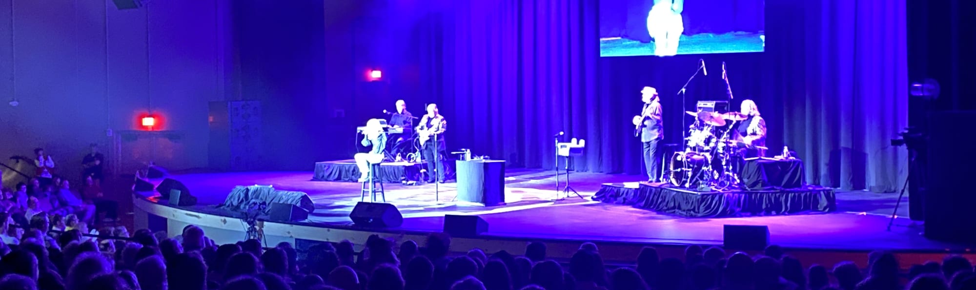 signer on stage in chair washed out by the lights Memphis